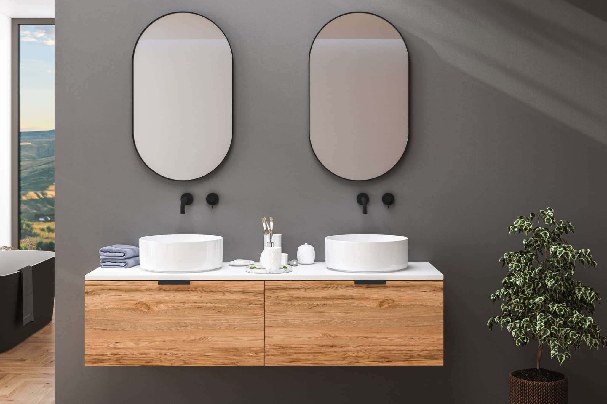 Dark bathroom interior with hardwood parquet floor, black bathtub