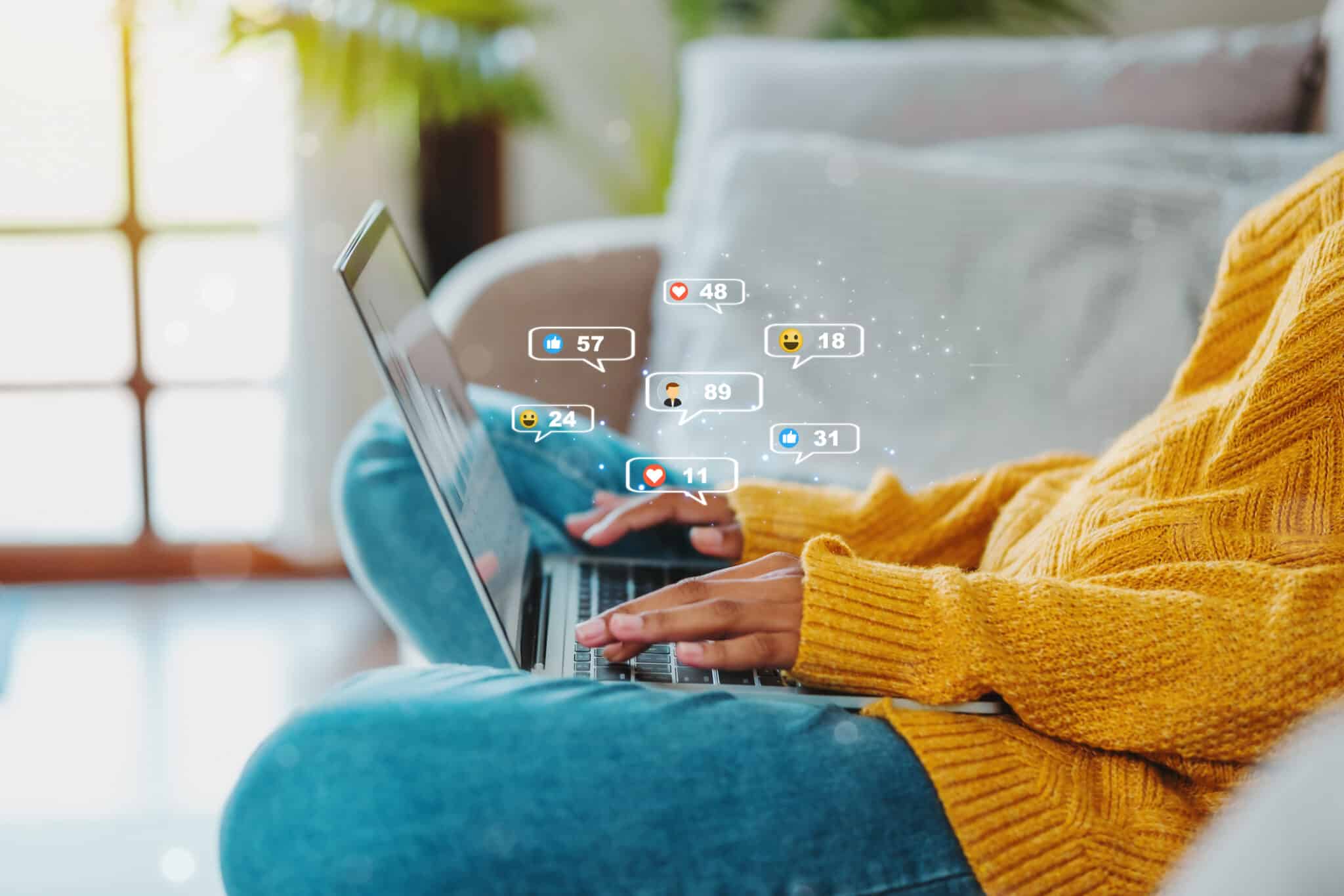 African Americamarketing-inmobiliario-digitaln teenage woman using a smartphone ,Laptop with Icon communication network social media network pop notification concept. 4. Invierte en tu presencia y contenido en redes sociales | Marketing Inmobiliario Digital